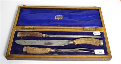 Lot 422 - An oak cased three piece antler handled carving set retailed by Harrods of London