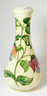 Lot 436 - A Walter Moorcroft Fuchsia pattern lamp, on a white ground, impressed factory marks and printed...