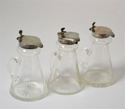 Lot 472 - A set of three silver mounted whisky noggins