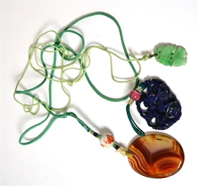 Lot 482 - A carved lapis lazuli pendant, a carved jade pendant and an agate pendant