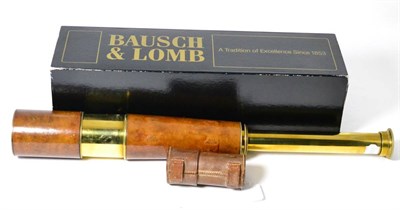 Lot 518 - An early 20th century brass and leather telescope and a boxed Bausch & Lomb elite telescope