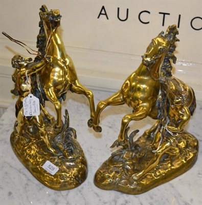 Lot 528 - A pair of brass marley horses