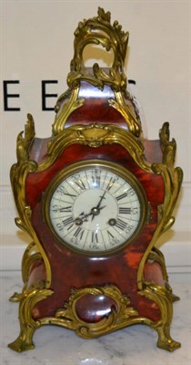 Lot 529 - A faux tortoiseshell striking mantel clock