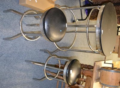 Lot 1048 - A modern chrome table together with a pair of matching stools