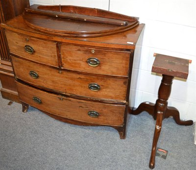 Lot 1100 - A Georgian mahogany snap-top tripod table and a bow fronted three height chest of drawers