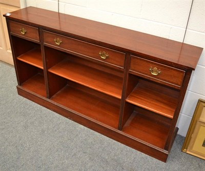 Lot 1107 - A modern low bookcase fitted with three frieze drawers