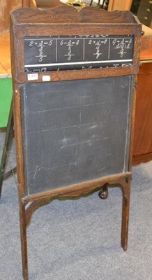 Lot 1119 - A 1920s oak metamorphic schoolroom blackboard/desk surmounted by changeable scroll with turned...