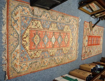 Lot 1141 - A Melas rug, East Anatolia, the terracotta field with two columns of stylised flowerheads...