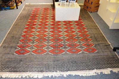 Lot 1146 - A Pakistan Bukhara carpet, Lahore, the field with five columns of stepped octagons enclosed by...