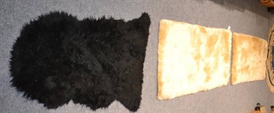 Lot 1147 - Four rugs including a sheepskin, a Chinese circular rug and two mohair rugs