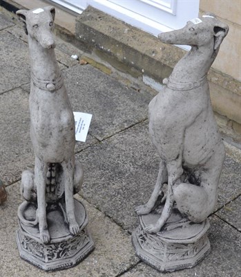 Lot 1162 - A pair of composition sculptures of whippets seated on octagonal bases, 80cm high