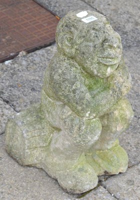 Lot 1165 - A hand carved stone seated gargoyle/grotesque figure, 45cm by 24cm