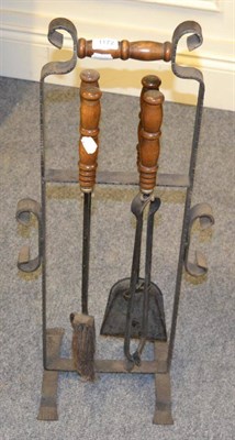 Lot 1172 - A wooden handle cast iron companion set