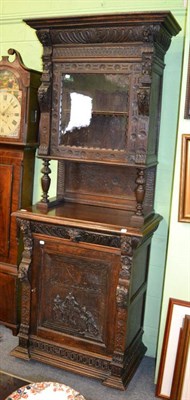 Lot 1176 - An 19th century carved oak cabinet, the upper section decorated with caryatids flaking a glazed...