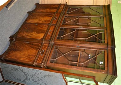 Lot 1187 - A reproduction string inlaid mahogany astragal glazed break front bookcase