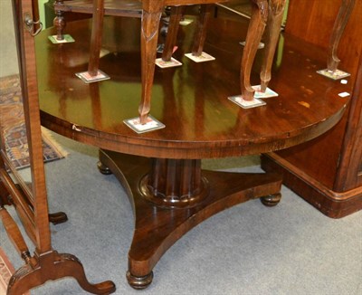 Lot 1205 - A 19th century mahogany circular topped table with boldly fluted column, on a waisted tri-form base