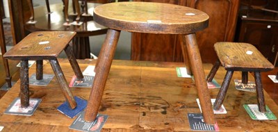 Lot 1218 - A Welsh pine milking stool together with a pair of small stools