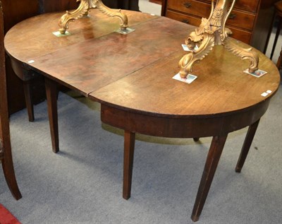 Lot 1223 - A 19th century mahogany dining table with two D-ends and a central leaf