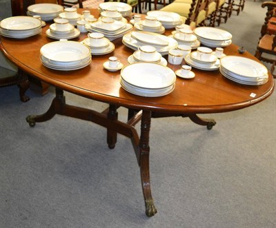 Lot 1226 - A 19th century mahogany gateleg oval dining table, raised on turned uprights and brass capped...