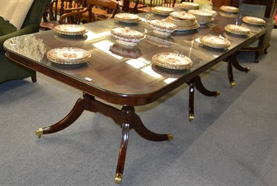 Lot 1228 - A substantial mahogany dining table on three pedestals