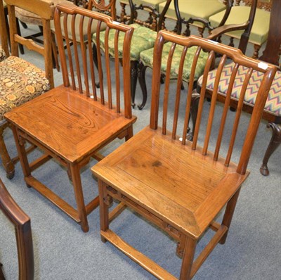 Lot 1235 - A pair of Chinese elm Shanghai chairs