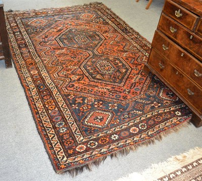 Lot 1263 - A Shiraz rug, South West Persia, the deep terracotta field with two linked medallions framed by...