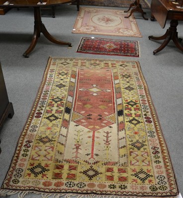 Lot 1264 - A Melas rug, West Anatolia, the faded aubergine field beneath the Mihrab enclosed by pale lemon...