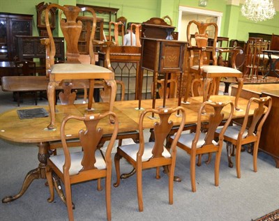 Lot 1269 - Reproduction walnut tri-pedestal dining table together with ten chairs (including two carvers)