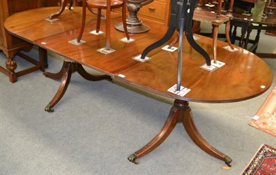 Lot 1273 - A reproduction twin pedestal dining table in solid mahogany, with one leaf