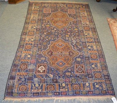 Lot 1291 - A Balouch rug, West Afghanistan, the indigo field with two medallions surrounded by tribal and...