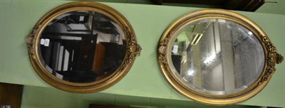 Lot 1293 - A pair of Victorian decorative oval gilt framed wall mirrors