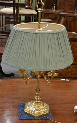 Lot 1395 - A brass three light table lamp with green silk shade