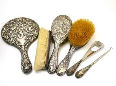 Lot 10 - A matched silver dressing table set comprising three brushes, hand mirror, shoe horn and a...