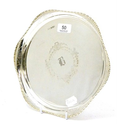 Lot 50 - A silver waiter with shaped beaded rim, marked for Sheffield