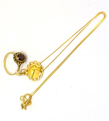 Lot 95 - A Middle Eastern pendant on chain stamped '750' together with a 9ct gold garnet set ring (2)