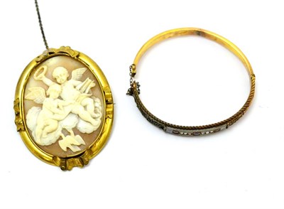 Lot 98 - A 15ct gold bangle and a cameo brooch