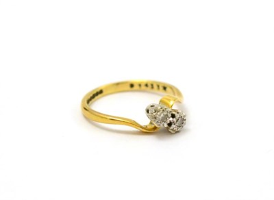 Lot 107 - An 18ct gold diamond two stone twist ring