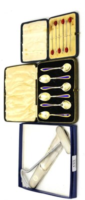 Lot 133 - A group of cased silver including toothpicks, enamel decorated teaspoons and a matching boot...