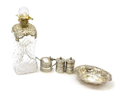 Lot 136 - Silver mounted dimpled glass decanter, three piece silver condiment set and silver dish