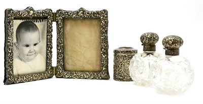 Lot 137 - A pair of cut glass and silver bottles and stoppers, silver double picture frame and a silver...