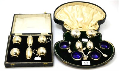 Lot 138 - A cased silver six piece condiment set together with an eight piece silver condiment set (2)