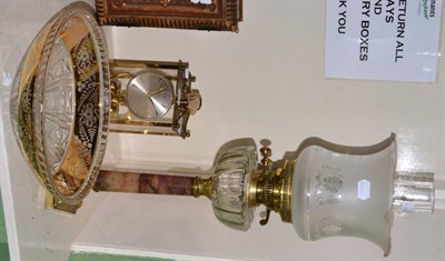 Lot 158 - A late 19th/early 20th century carved oak aneroid barometer, German clock and an oil lamp