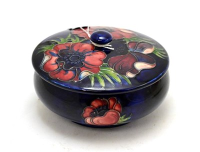 Lot 185 - Dark blue Moorcroft Poppy pattern jar and cover, bearing Queen Mary label