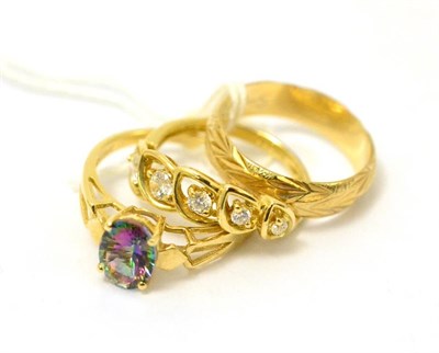 Lot 248 - A 14ct gold dress ring and a mystic topaz ring stamped '14K' a 9ct gold band ring (3)