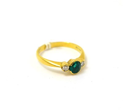 Lot 319 - An emerald and diamond three stone ring