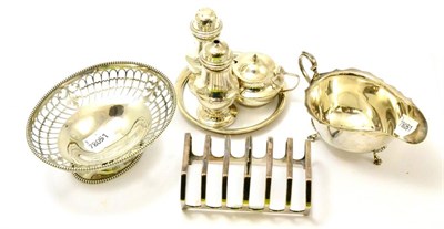 Lot 352 - Silver comprising toast rack, oval pedestal dish, sauce boat and condiment set with stand