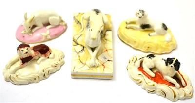 Lot 386 - Four English porcelain models of dogs on beds and a Chamberlains model of a rabbit