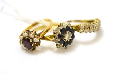 Lot 408 - An 18ct gold diamond and sapphire cluster ring (worn), a 9ct gold cz ring and a 9ct gold garnet and