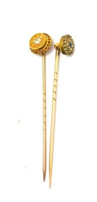 Lot 409 - Two diamond set stick pins