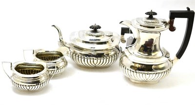 Lot 443 - A silver four piece tea set with part gadrooned body